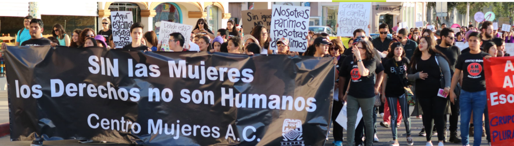 Centro Mujeres partners and supporters carrying a banner at a pro-choice demonstration.